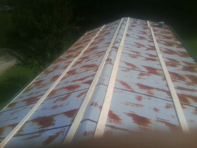 Rusted metal roof panels with new wood purlins before replacement — Storm Damage Roof Repair in Kerrville by Roofing Brothers